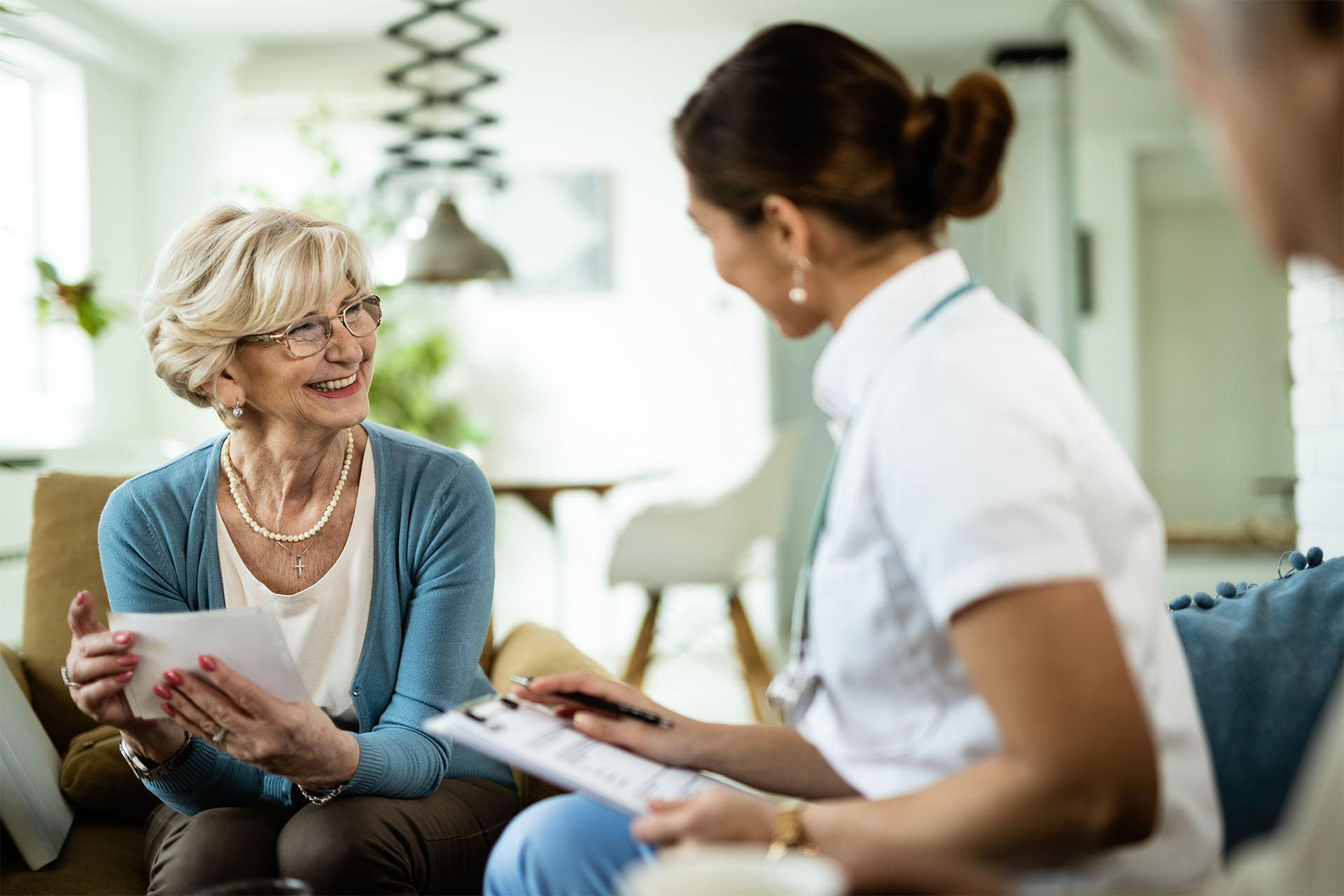 Our skilled nurse talks to Best Senior Homes' residents about all-inclusive residential care service with a smile.